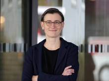 Frau mit kurzen Haaren, Brille und dunklem Sakko